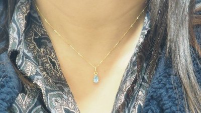 Yellow gold and blue topaz solitaire necklace