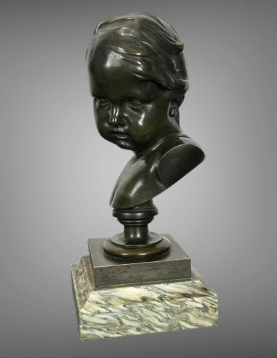 PATINATED BRONZE BUST OF A PUTTO AFTER FRANCOIS DUQUESNOY ON MARBLE BASE