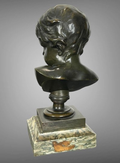 PATINATED BRONZE BUST OF A PUTTO AFTER FRANCOIS DUQUESNOY ON MARBLE BASE