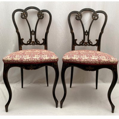 Pair of Napoleon III chairs, blackened wood and gold decor