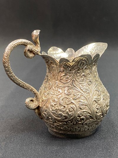 Milk jug in richly chased solid silver with Indo-Persian design and cobra handle