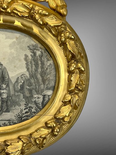 EIGHTEENTH CENTURY OVAL FRAME IN GILDED SCULPTTED WOOD AND ITS FURNACED FRONTIER