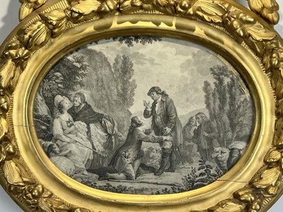 EIGHTEENTH CENTURY OVAL FRAME IN GILDED SCULPTTED WOOD AND ITS FURNACED FRONTIER