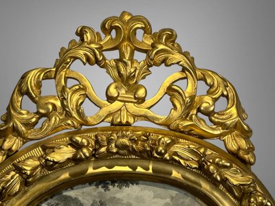 EIGHTEENTH CENTURY OVAL FRAME IN GILDED SCULPTTED WOOD AND ITS FURNACED FRONTIER