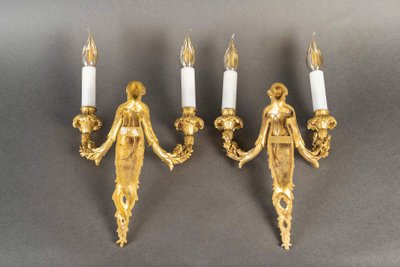 A pair of Louis XVI style Aux Termes de Femmes sconces in chiseled and gilt bronze circa 1850-1870