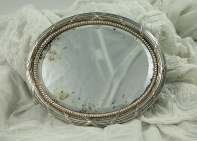 Small oval beveled mirror with solid silver frame circa 1900