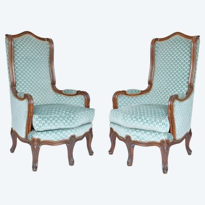 Pair of Louis XV style wingback armchairs with five legs