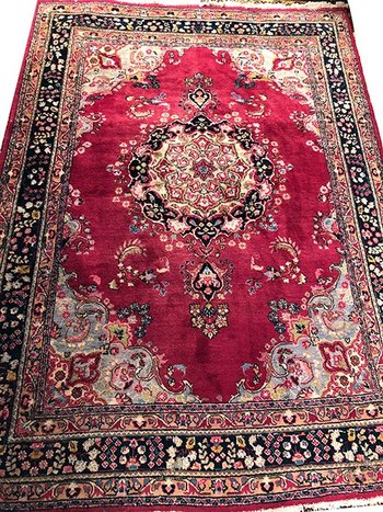 Iranian wool carpet with central medallion decoration on pink background