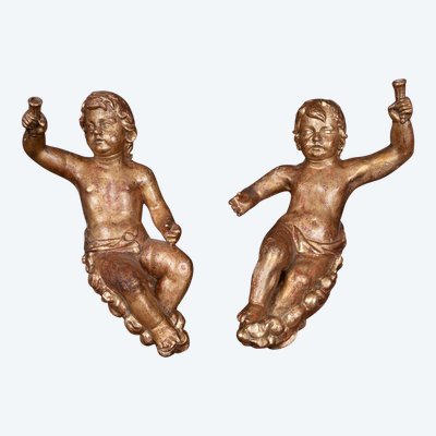 Pair of antique single-trunk cherubs in gilded wood. Florence, late 17th century.