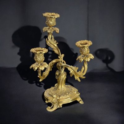 PAIR OF LATE 19TH CENTURY GILT-BRONZE THREE-BRANCH CANDLESTICKS IN LOUIS XV STYLE