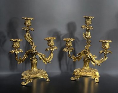 PAIR OF LATE 19TH CENTURY GILT-BRONZE THREE-BRANCH CANDLESTICKS IN LOUIS XV STYLE