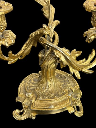 PAIR OF LATE 19TH CENTURY GILT-BRONZE THREE-BRANCH CANDLESTICKS IN LOUIS XV STYLE