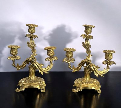 PAIR OF LATE 19TH CENTURY GILT-BRONZE THREE-BRANCH CANDLESTICKS IN LOUIS XV STYLE