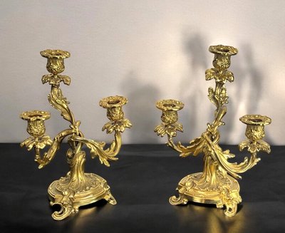 PAIR OF LATE 19TH CENTURY GILT-BRONZE THREE-BRANCH CANDLESTICKS IN LOUIS XV STYLE