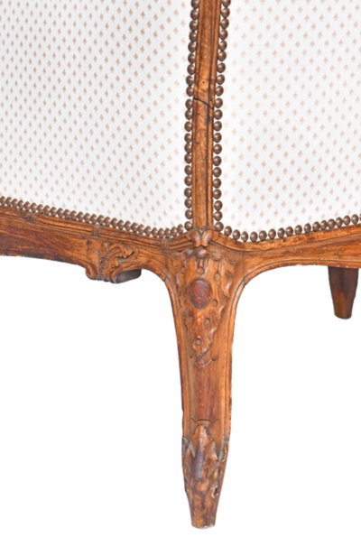 Louis XV style wing chair in richly carved wood