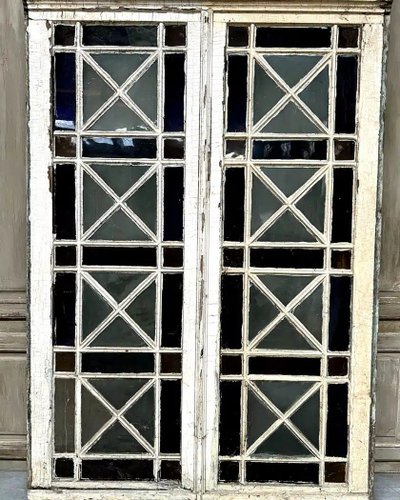 Double orangery door and its pair of colored glass bay windows