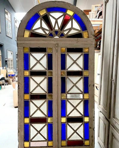 Double orangery door and its pair of colored glass bay windows