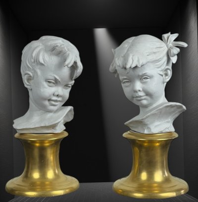 PAIR OF BISQUE CHILDREN'S BUSTS SIGNED BRUNO MERLI ON PORCELAIN BASE