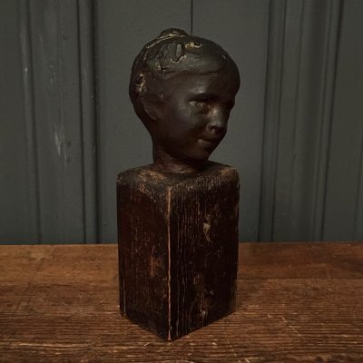 Studio plaster by Charles Filleul depicting a young boy on a wooden base