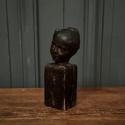 Studio plaster by Charles Filleul depicting a young boy on a wooden base