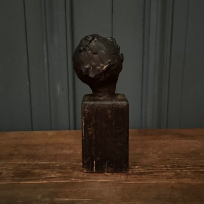 Studio plaster by Charles Filleul depicting a young boy on a wooden base