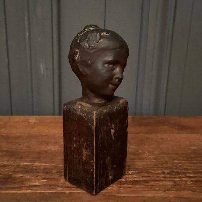 Studio plaster by Charles Filleul depicting a young boy on a wooden base