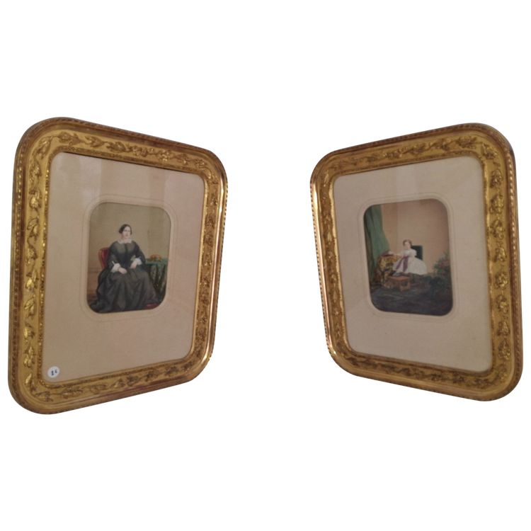 pair of colorized photos, family portraits framed in gold leaf