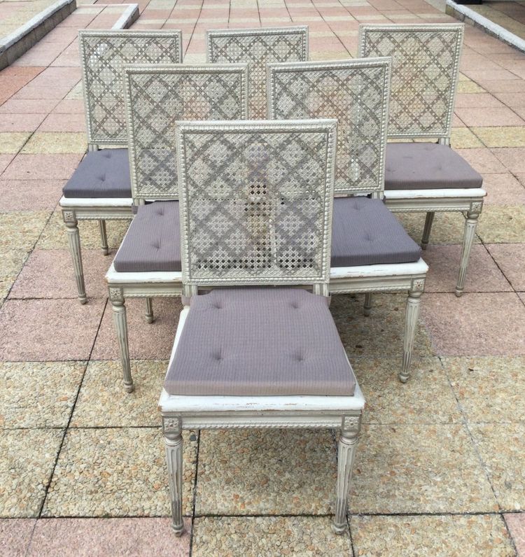 Set of six Louis XVI caned chairs in rechampi wood.