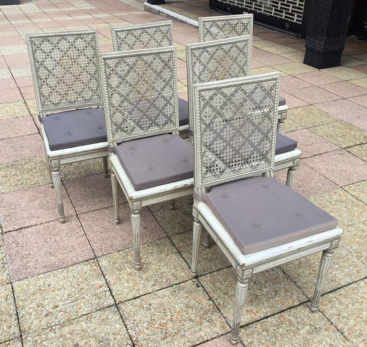 Set of six Louis XVI caned chairs in rechampi wood.