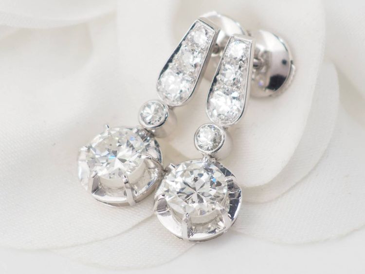 Pair of antique sleeper earrings in white gold and diamonds