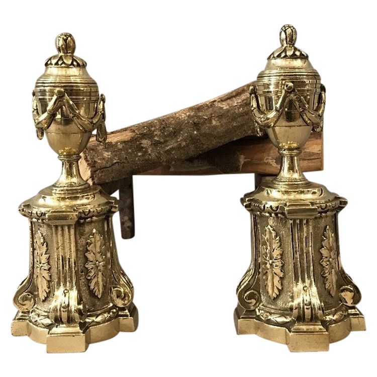 Pair of antique bronze andirons from the 19th century in Louis XVI style