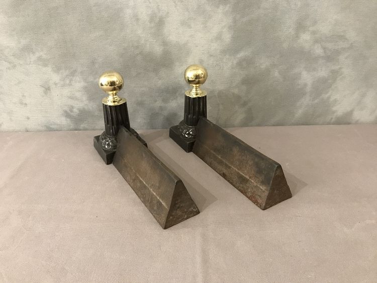 Pair of antique cast iron and brass andirons from the 19th century