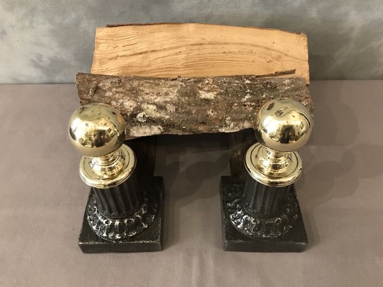 Pair of antique cast iron and brass andirons from the 19th century