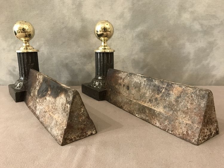 Pair of antique cast iron and brass andirons from the 19th century