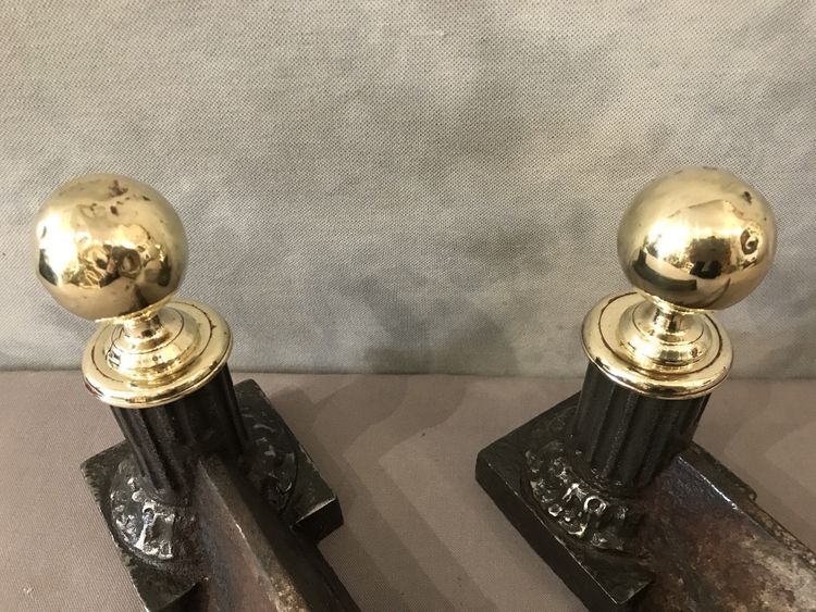 Pair of antique cast iron and brass andirons from the 19th century