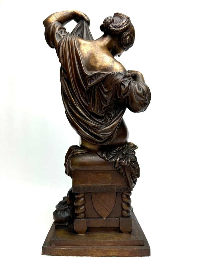 Bronze Sculpture of a Seated Woman Undressing