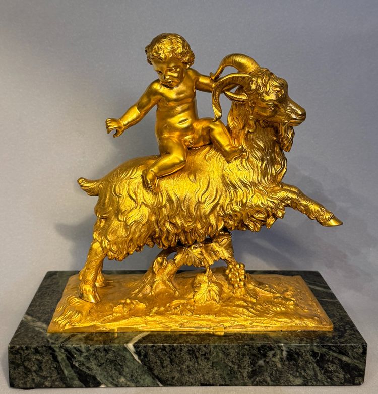 Scultura in bronzo dorato Bacco o putto su capra XIX secolo