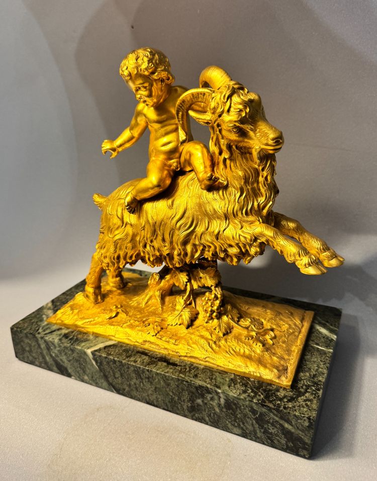 Scultura in bronzo dorato Bacco o putto su capra XIX secolo