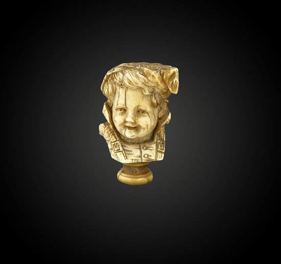 CANE KNOB carved in the round of a CHILD'S HEAD in costume