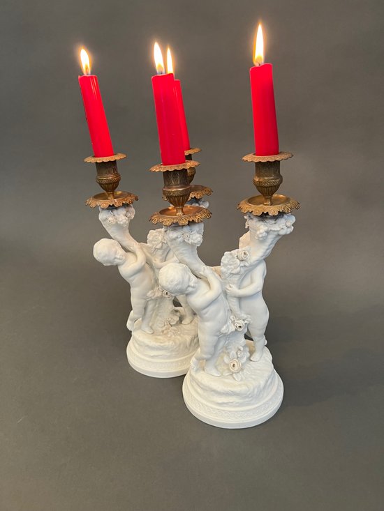 Pair of candlestick in cookie of Sevres with putti