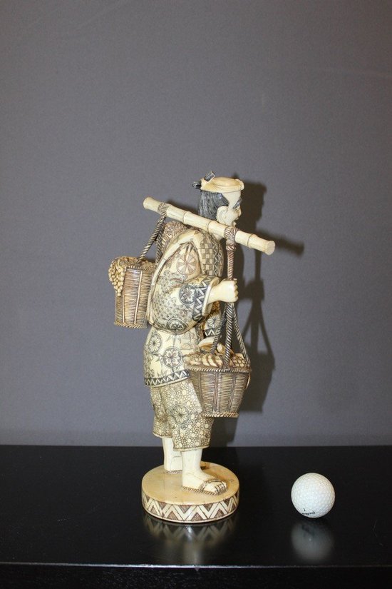 Asian Okimono Bone Carving of a Vegetable Vendor, Japan About 1900