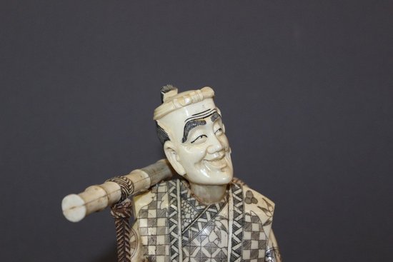 Asian Okimono Bone Carving of a Vegetable Vendor, Japan About 1900