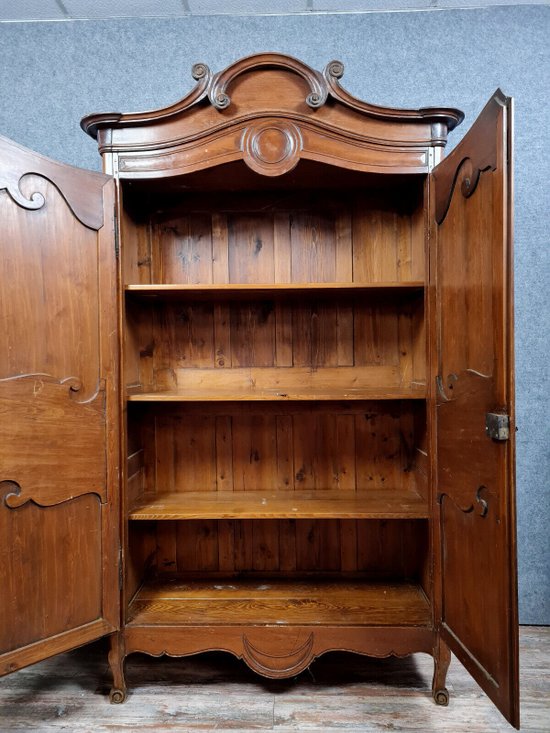 Louis XV period Cauchoise cabinet with gendarme hat in solid pine around 1750