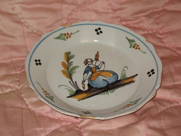 Pair of earthenware plates from Nevers, 18th century: the spinner - the dog