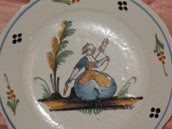 Pair of earthenware plates from Nevers, 18th century: the spinner - the dog