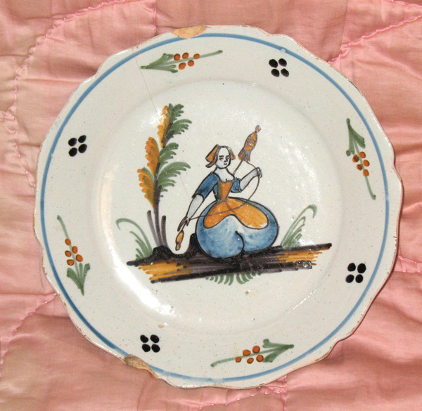 Pair of earthenware plates from Nevers, 18th century: the spinner - the dog