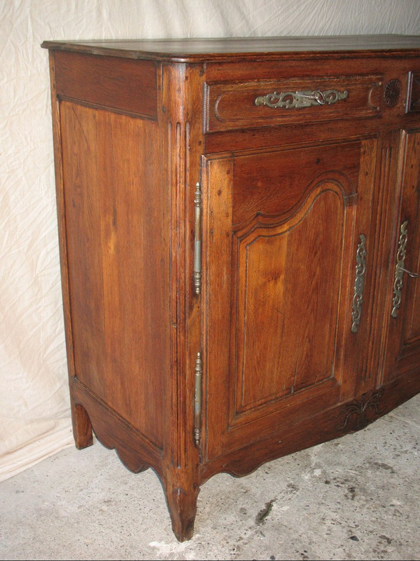 Low sideboard in molded and carved oak in the Louis XV style, 19th century