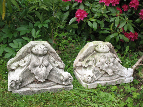 Pair of gothic style stone wall brackets decorated with plants