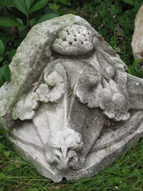 Pair of gothic style stone wall brackets decorated with plants