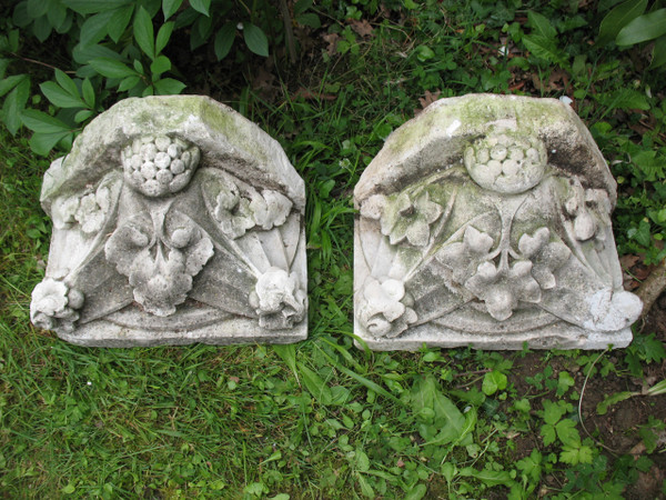 Pair of gothic style stone wall brackets decorated with plants